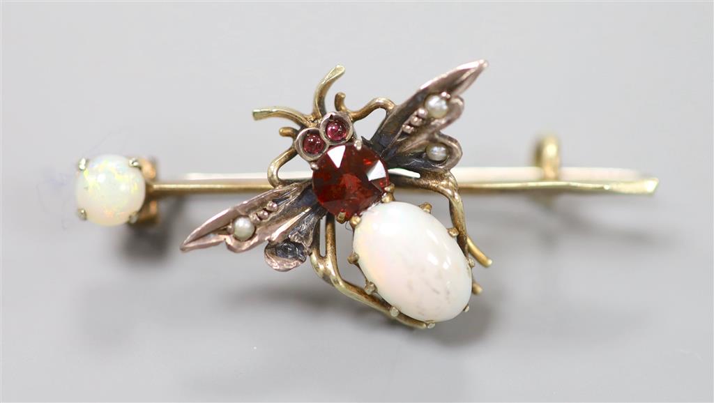 A Victorian yellow and white metal, white opal, garnet and seed pearl set bug brooch, 37mm, gross 2.7 grams.